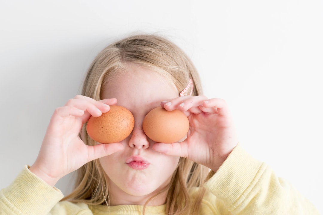 girl holding two eggs while putting it on her eyes ZBkH8G4 yyE jpg